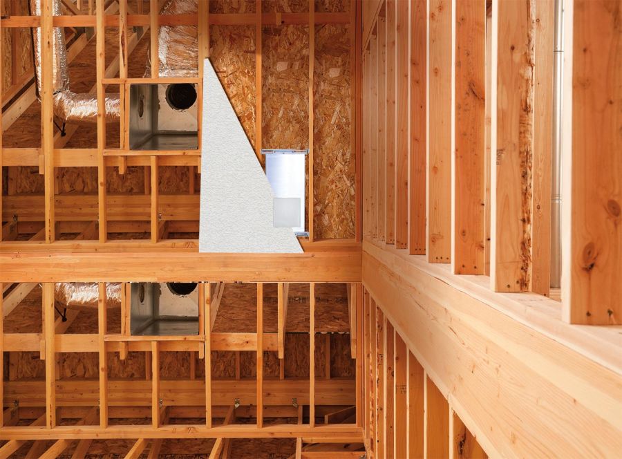 In-wall speaker enclosure mounted to wooden studs during home construction