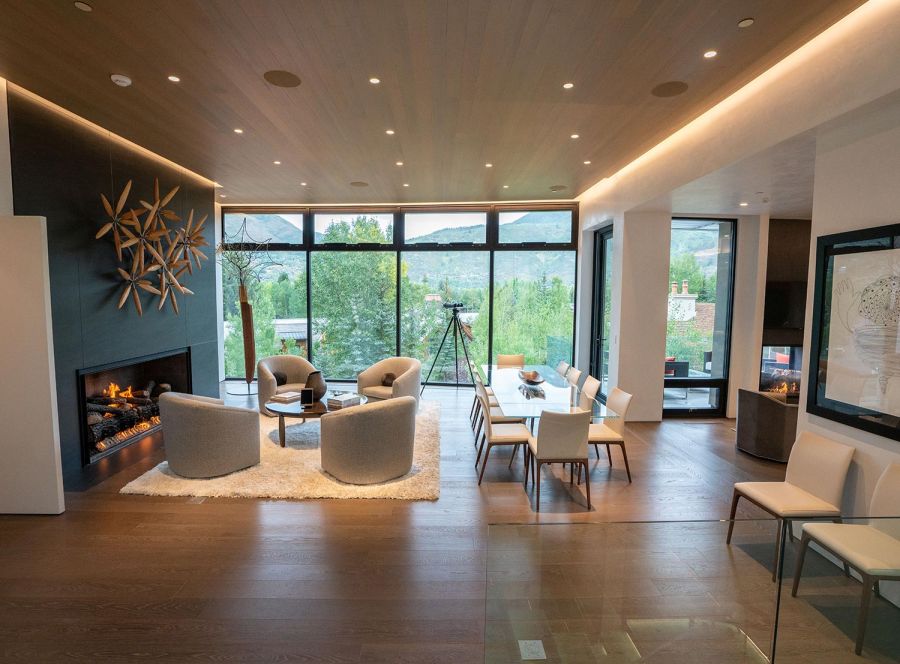 Modern living room with circular ceiling speakers and large windows