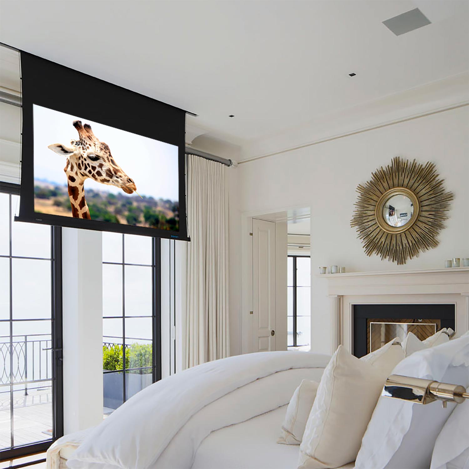 Retractable projector screen showing a giraffe in a bright white bedroom