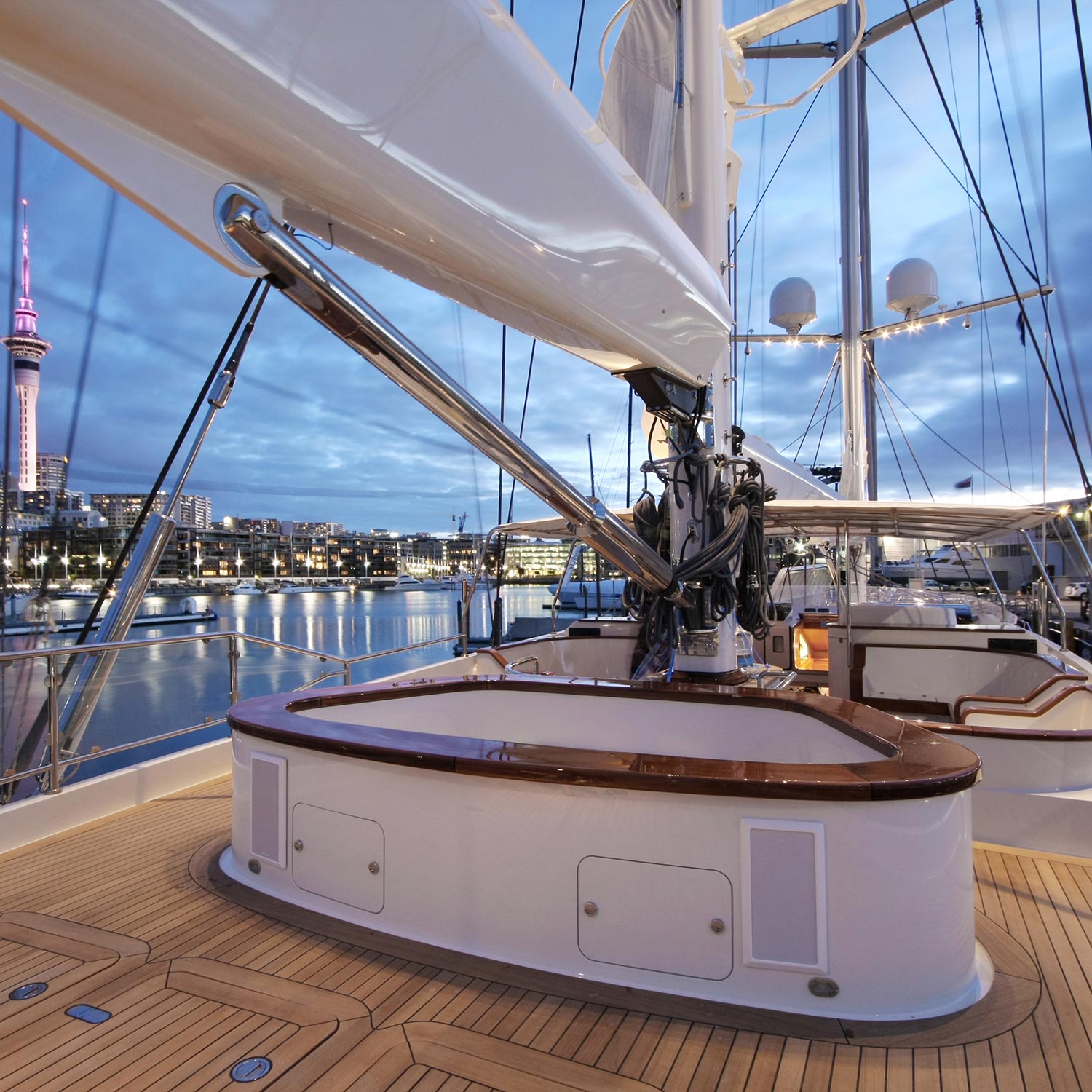 Luxury yacht deck with integrated speakers and a harbor view at dusk