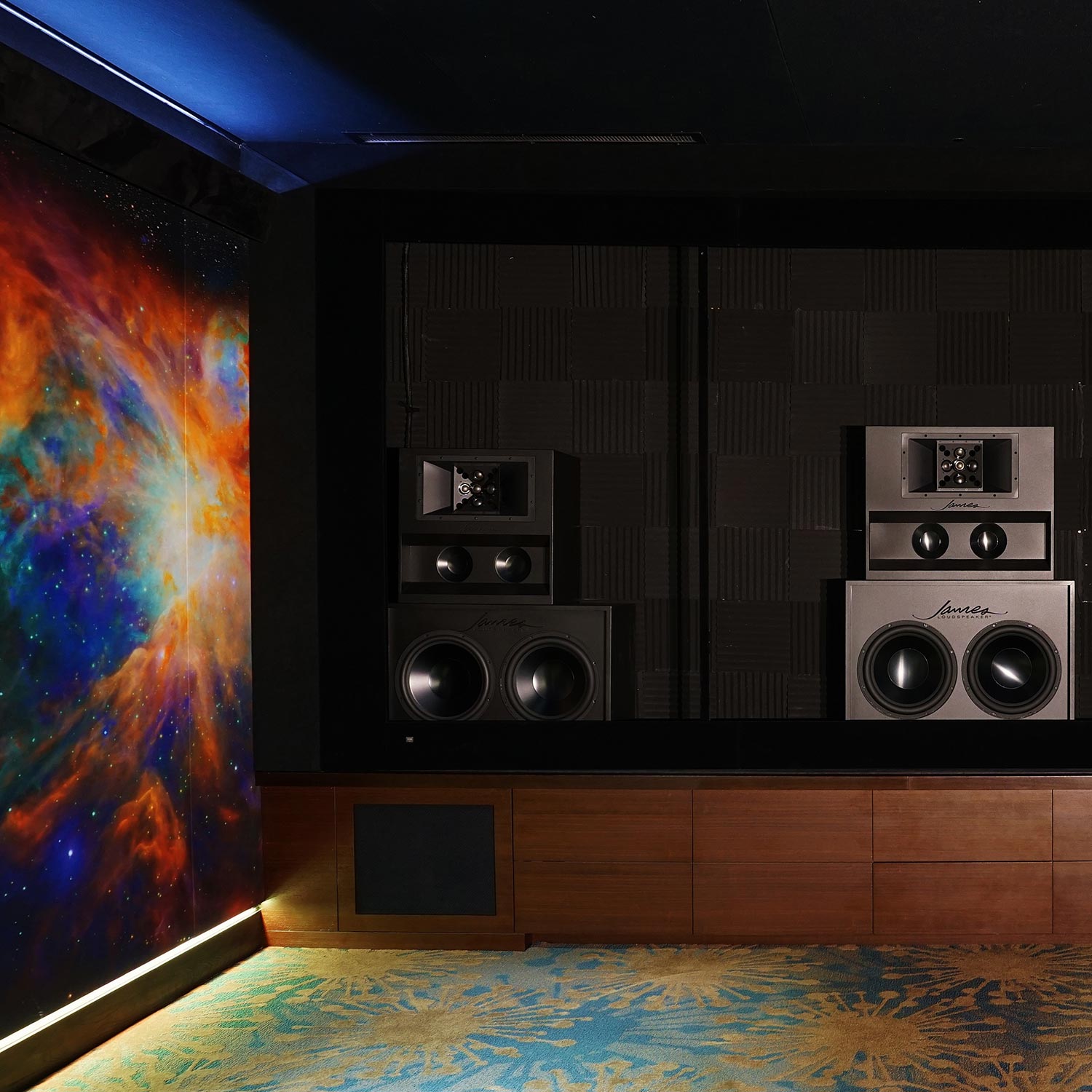 Professional home theater speakers mounted against acoustic wall panels