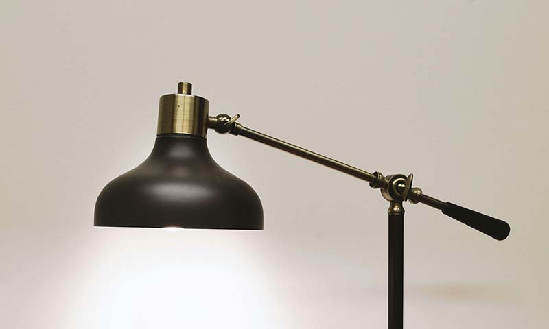 a black desklamp turned on